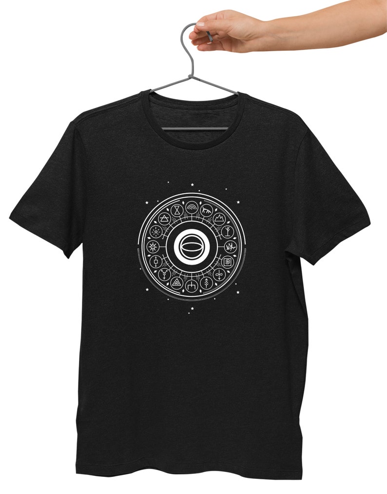 May include: A black t-shirt with a white graphic of a circle with symbols around it. The symbols include a sun, a moon, a tree, a mountain, and a star.