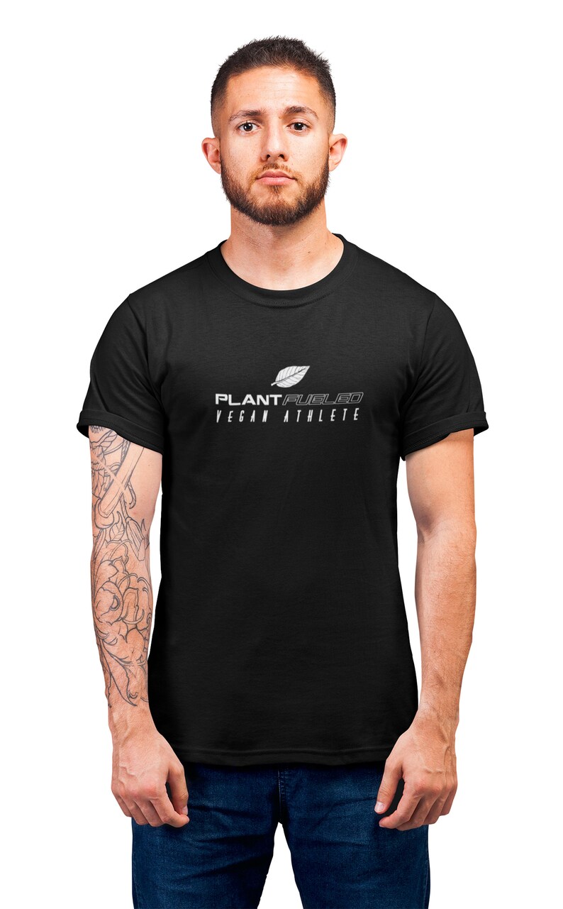 May include: A black t-shirt with a white graphic design that says "PLANT FUELED VEGAN ATHLETE" and a stylized leaf.