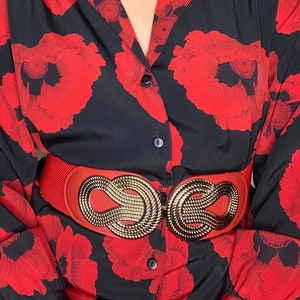 Vintage 70s Red wide elastic stretch belt with gold decorative ornamental rope design front buckle closure on a leather oval shape backing