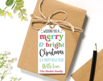 May include: A wrapped gift with a brown paper exterior and a twine bow. A white tag with the text "Wishing you a merry & bright Christmas & a Happy New Year! With Love, The Hinkle Family" is attached to the gift.