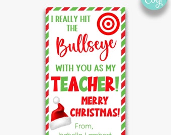May include: A Christmas-themed gift tag with a red and green striped border. The tag reads "I REALLY HIT THE Bullseye WITH YOU AS MY TEACHER! MERRY CHRISTMAS!" and includes a Santa hat graphic. The tag is personalized with the name Isabella Lambert.