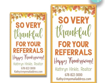May include: Two printable Thanksgiving-themed business cards with a fall leaf border. The text reads "So Very Thankful For Your Referrals Happy Thanksgiving!" with the name Kathryn Hinkle, Realtor, phone number and email address. The cards are available in two sizes: 2 inches by 3.5 inches and 2.5 inches by 4 inches.