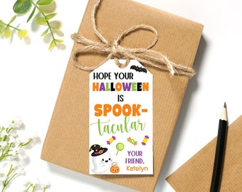 May include: White gift tag with a ghost, candy, and bat illustration. The text reads "Hope your Halloween is Spook-tacular. Your friend, Katelyn."