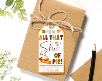 May include: A white gift tag with a fall-themed design. It features a slice of pumpkin pie with a red, orange, and yellow leaf design. The text reads "You are all that and a slice of pie!" and "Wishing you a happy Thanksgiving! Love, The Hinkle Family."