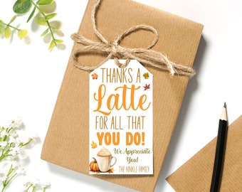 May include: A white gift tag with the text "Thanks a Latte for all that you do! We Appreciate You! The Hinkle Family."  The tag is decorated with a fall-themed latte, a pumpkin, and autumn leaves.