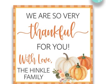 May include: A white printable Thanksgiving tag with orange and white checkered border. The tag says "We are so very thankful for you! With love, The Hinkle Family". The tag is decorated with three pumpkins and a floral arrangement.