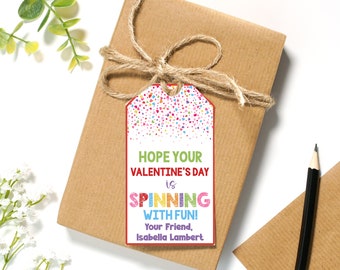May include: A colorful Valentine's Day gift tag with confetti and the text "Hope your Valentine's Day is spinning with fun! Your friend, Isabella Lambert."