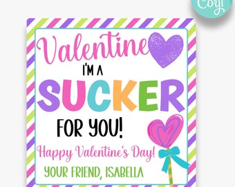 May include: A Valentine's Day card with a colorful striped background. The card says "Valentine I'm a sucker for you!" with a pink and white lollipop and a purple heart. The card is signed "Happy Valentine's Day! Your friend, Isabella."