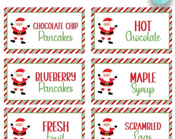 May include: Six printable Christmas food labels featuring a cartoon Santa Claus. The labels are red and green striped with white text. The labels read: Chocolate Chip Pancakes, Hot Chocolate, Blueberry Pancakes, Maple Syrup, Fresh Fruit, and Scrambled Eggs.