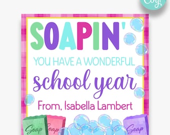 May include: A pink and white checkered background with a white rectangle in the center. The rectangle has the text "SOAPIN' YOU HAVE A WONDERFUL school year From, Isabella Lambert" in colorful letters. There are three bars of soap with the word "Soap" on them and blue bubbles around the bars of soap.