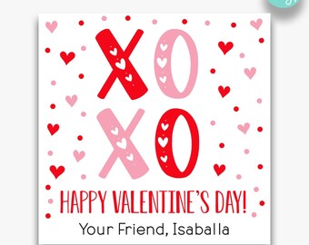 May include: A printable Valentine's Day card with a red and pink XOXO design. The card has a white background with red and pink hearts scattered around the XOXO design. The text "Happy Valentine's Day!" and "Your Friend, Isaballa" is printed on the card. The card is available in two sizes: 2 inches by 2 inches and 3.5 inches by 3.5 inches.