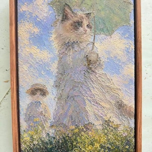 May include: Oil painting of a cat holding a green umbrella, dressed in a long dress, with a child in a hat. The artwork is set in a field of yellow flowers under a blue sky with clouds. The painting is framed in a wooden frame.