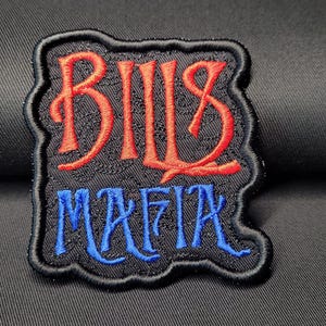 May include: Black embroidered patch with the words "BILLS MAFIA" in red and blue thread.