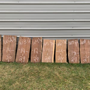 May include: Nine wooden boards with white markings. The boards are labeled W1 1/7, W2 3/4, W3 1/2, W4 1/8, W5 8/4, W6 1/8, W7 1/4, W8 3/4, and W9 3/4. Each board has a number written on it, ranging from 11 to 14, and a number ranging from 26 to 30.