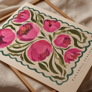 May include: A botanical illustration art print features a stylized arrangement of pink peonies with green foliage, set against a cream background. The design is framed by a scalloped teal border. Text at the bottom reads: PAEONIA TENUIFOLIA THE FERN LEAF PEONY.