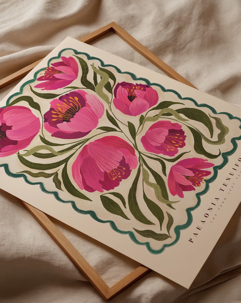 May include: A botanical illustration art print features a stylized arrangement of pink peonies with green foliage, set against a cream background. The design is framed by a scalloped teal border. Text at the bottom reads: PAEONIA TENUIFOLIA THE FERN LEAF PEONY.