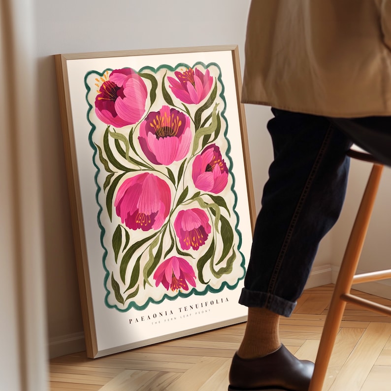 May include: A botanical illustration art print features pink Paeonia tenuifolia, also known as the fern leaf peony, depicted in a vintage style. The flowers are rendered with vibrant pink hues and detailed brushstrokes against a cream background, framed by a teal border. The print's title, 'Paeonia Tenuifolia The Fern Leaf Peony,' is subtly displayed at the bottom.