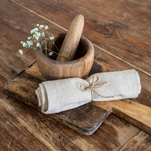 a wooden mortar and mortar bowl on a wooden table