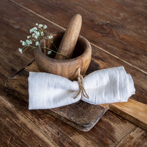 a wooden mortar bowl with a cloth napkin tied around it