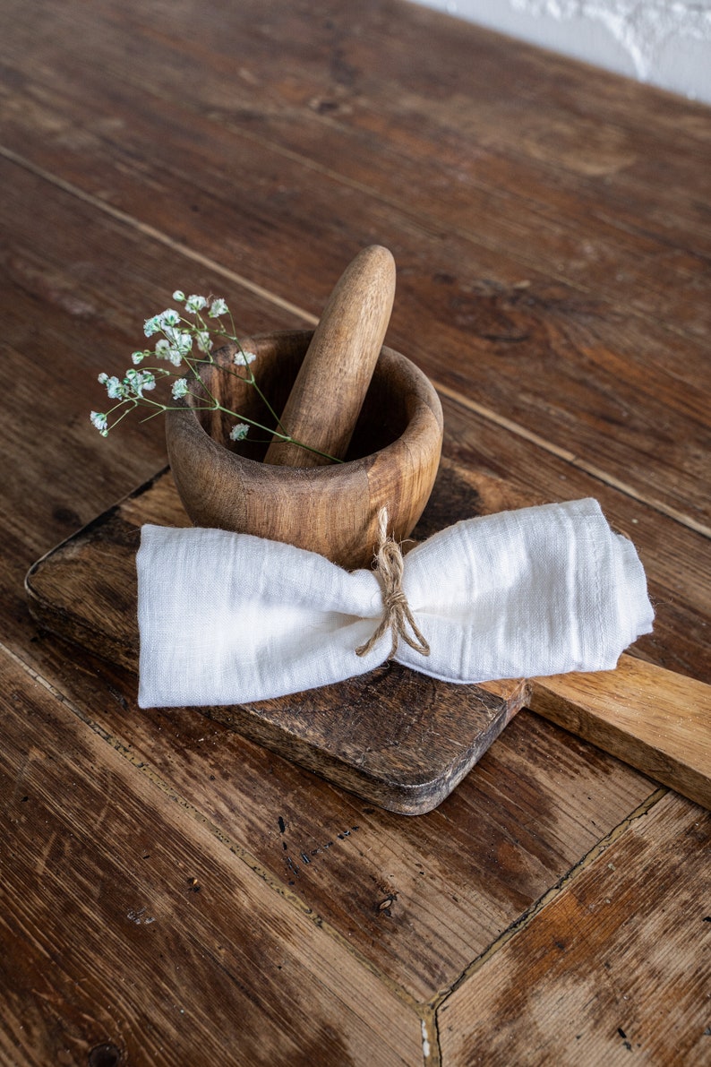 a wooden mortar bowl with a cloth napkin tied around it