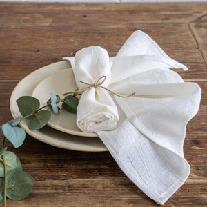 a plate with a napkin and a flower on it