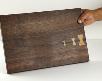 Walnut Wood cutting board with White Oak bowties, a versatile piece perfect for entertaining or as a kitchen decor item.
