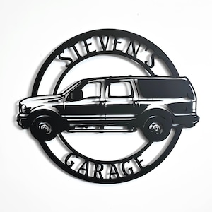 May include: Black metal sign with a silhouette of a truck and the text "Steven's Garage" in a circle.
