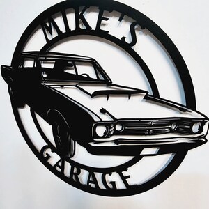 May include: Black metal silhouette of a classic car with the words "Mike's Garage" in a circle around it.