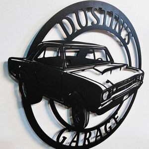 May include: Black metal silhouette of a classic car with the words "Dustin's Garage" in a circle around it.