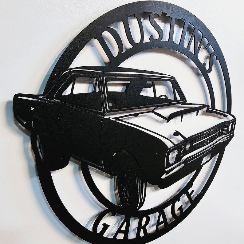 May include: Black metal silhouette of a classic car with the words "Dustin's Garage" in a circle around it.