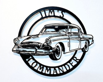 May include: Black and white metal wall art featuring a vintage car with the text "Jim's Commander" in a circle around it.