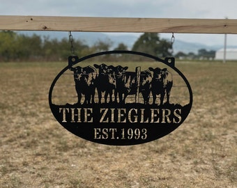 May include: Black metal oval sign with a silhouette of a herd of cattle and the text "The Zieglers Est. 1993".