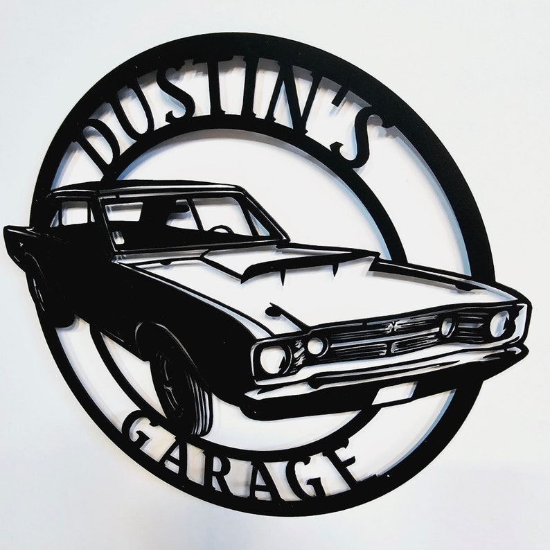 May include: Black metal sign with a silhouette of a classic car and the text "Dustin's Garage".