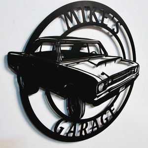 May include: Black metal silhouette of a classic car with the words "Mike's Garage" in a circle around it.
