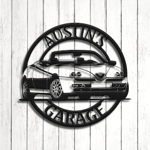 May include: Black metal sign with the text "Austin's Garage" in a circle. A black and white silhouette of a convertible car is in the center of the circle.