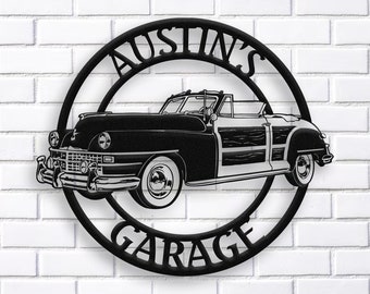 May include: Black metal sign with a circle design. The sign says "Austin's Garage" in a script font. A black and white silhouette of a vintage car is in the center of the circle.