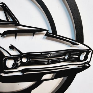 May include: Black and white illustration of a classic car, with a focus on the front grill and headlights. The car is set against a white background.