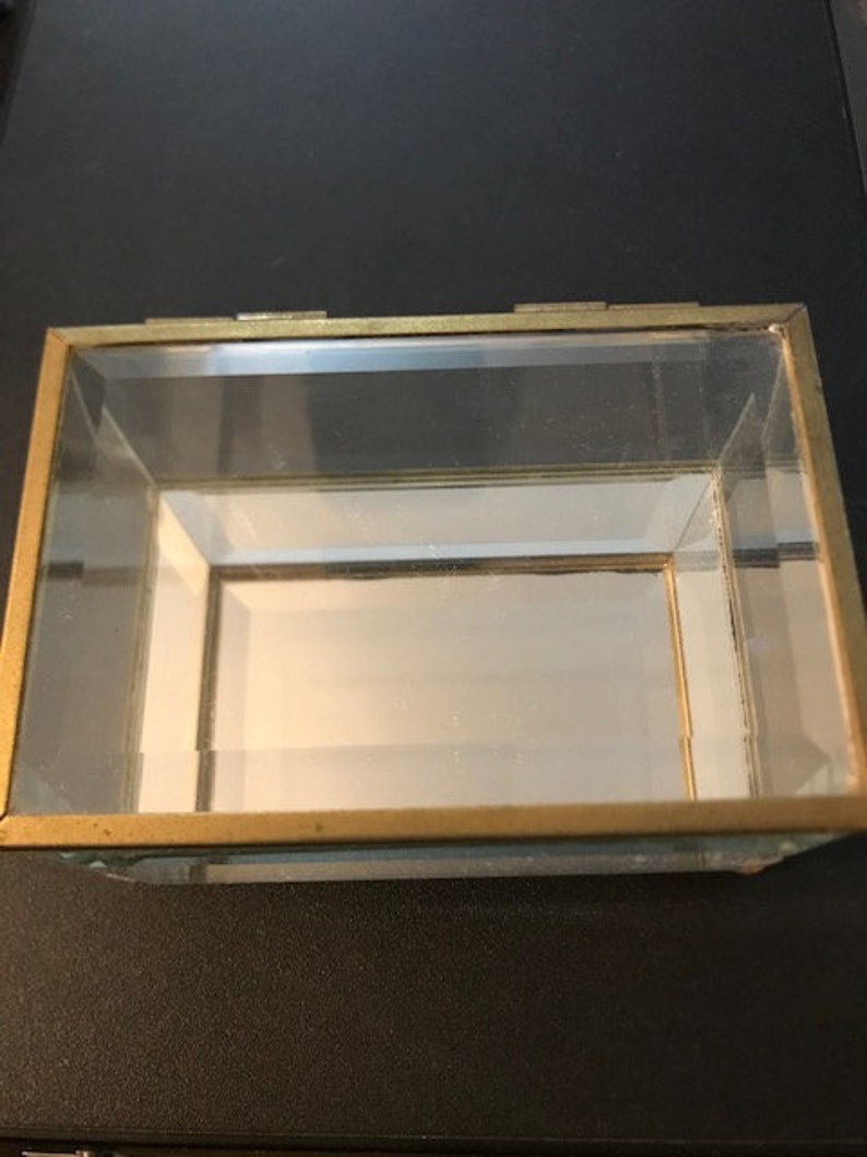 Vintage beveled glass rectangular box with mirrored bottom Measures 4 12L X 3W X 2 12H with feet Great for jewelry or collectibles.