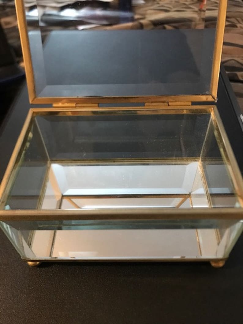 Vintage beveled glass rectangular box with mirrored bottom Measures 4 12L X 3W X 2 12H with feet Great for jewelry or collectibles.