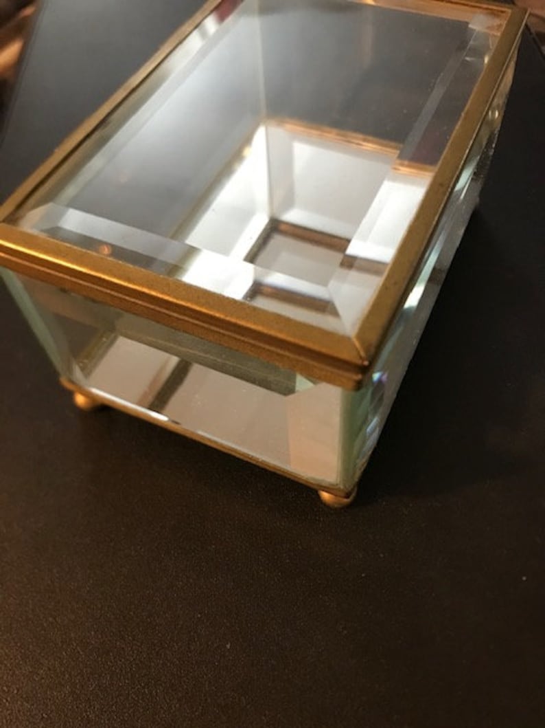 Vintage beveled glass rectangular box with mirrored bottom Measures 4 12L X 3W X 2 12H with feet Great for jewelry or collectibles.
