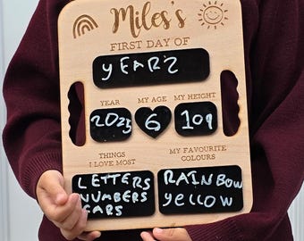 May include: A wooden first day of school sign with the name "Miles's" and the text "FIRST DAY OF YEARZ". The sign includes sections for year, age, height, favorite things, and favorite colors. The height is 109.