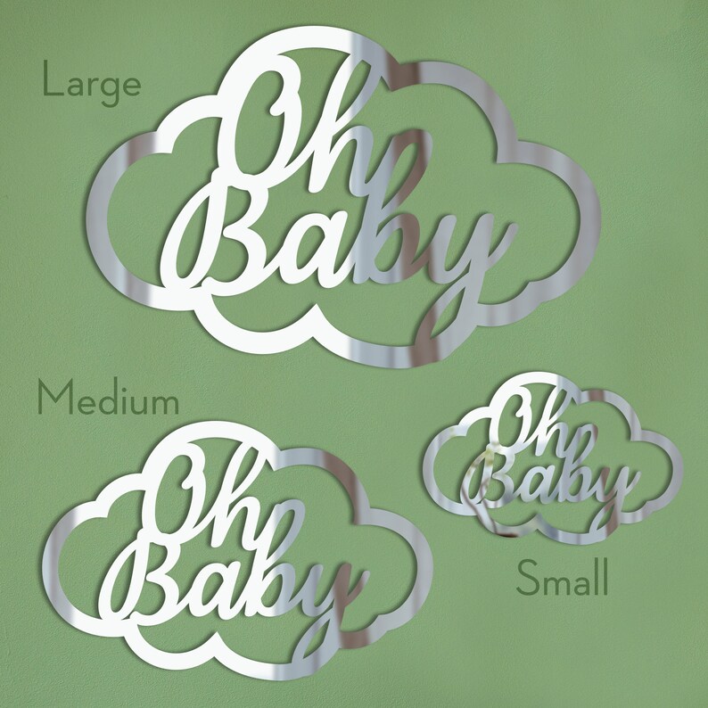 Może przedstawiać: Trzy srebrne, lustrzane kształty chmur z napisem "Oh Baby" napisanym kursywą. Chmury są w r&oacute;żnych rozmiarach, oznaczone jako "Large", "Medium" i "Small".