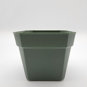 May include: A dark green plastic square planter with a slightly flared lip.