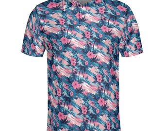 May include: A short-sleeved polo shirt with a vibrant tropical pattern. The shirt features a repeating design of pink hibiscus flowers and palm trees against a backdrop of blue and pink brushstrokes. The collar and button placket are visible.