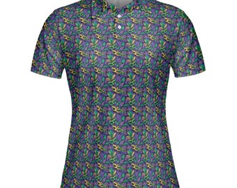 May include: A short-sleeved polo shirt with a vibrant, all-over pattern. The design features a repeating motif of green, gold, and purple elements on a dark purple background. The shirt has a collared neckline and a three-button placket.