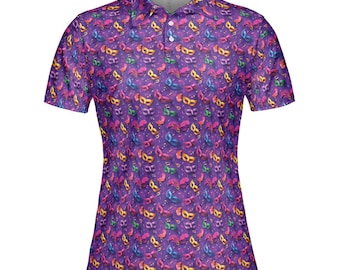 May include: A purple polo shirt with a repeating pattern of colorful masquerade masks. The masks are in various colors, including gold, blue, red, and green, with musical notes scattered throughout. The shirt has a collared neckline and short sleeves.