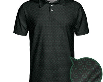 May include: Black polo shirt with a repeating green shamrock pattern. The shirt has a collared neckline and three white buttons. A close-up shows the shamrock design.