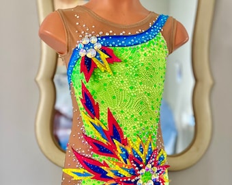 May include: A lime green leotard with a colorful floral design. The leotard has a scoop neck and a sleeveless design. The floral design is made of red, yellow, blue, and black fabric. The leotard is embellished with rhinestones.