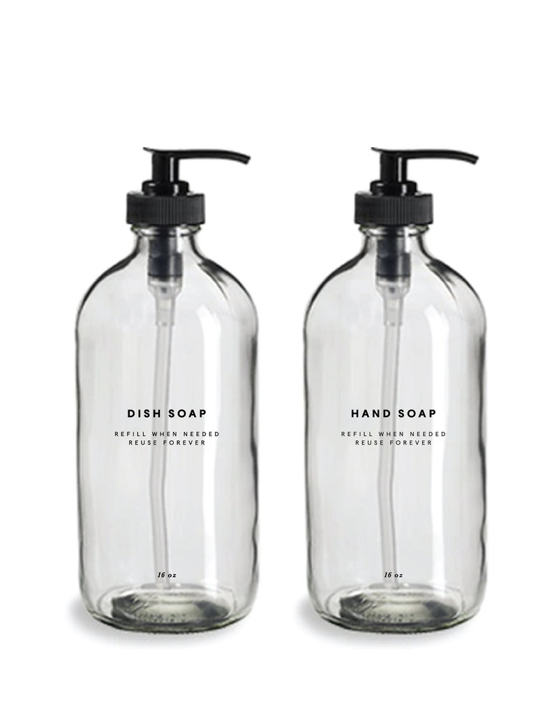 May include: Two clear glass bottles with black pump tops and labels that read "DISH SOAP REFILL WHEN NEEDED REUSE FOREVER" and "HAND SOAP REFILL WHEN NEEDED REUSE FOREVER". Each bottle contains 16 fluid ounces of liquid.