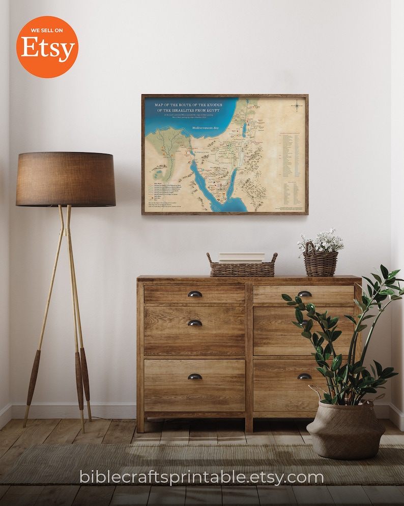 May include: A printable map of the route of the Exodus of the Israelites from Egypt. The map is printed on parchment paper and has a brown wooden frame. The map is displayed on a wall in a room with a wooden dresser, a lamp, and a potted plant.